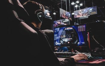 person sitting on gaming chair while playing video game